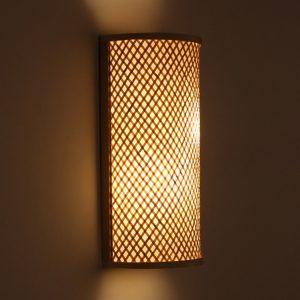 Stylish wall lamp made of bamboo and wood illuminating a cozy living room.