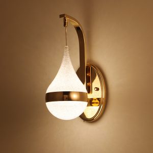 LED drop-shaped wall lamp illuminating a cozy bedroom with a warm glow.