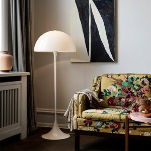 Sleek modern floor lamp with a minimalist design, illuminating a living room.